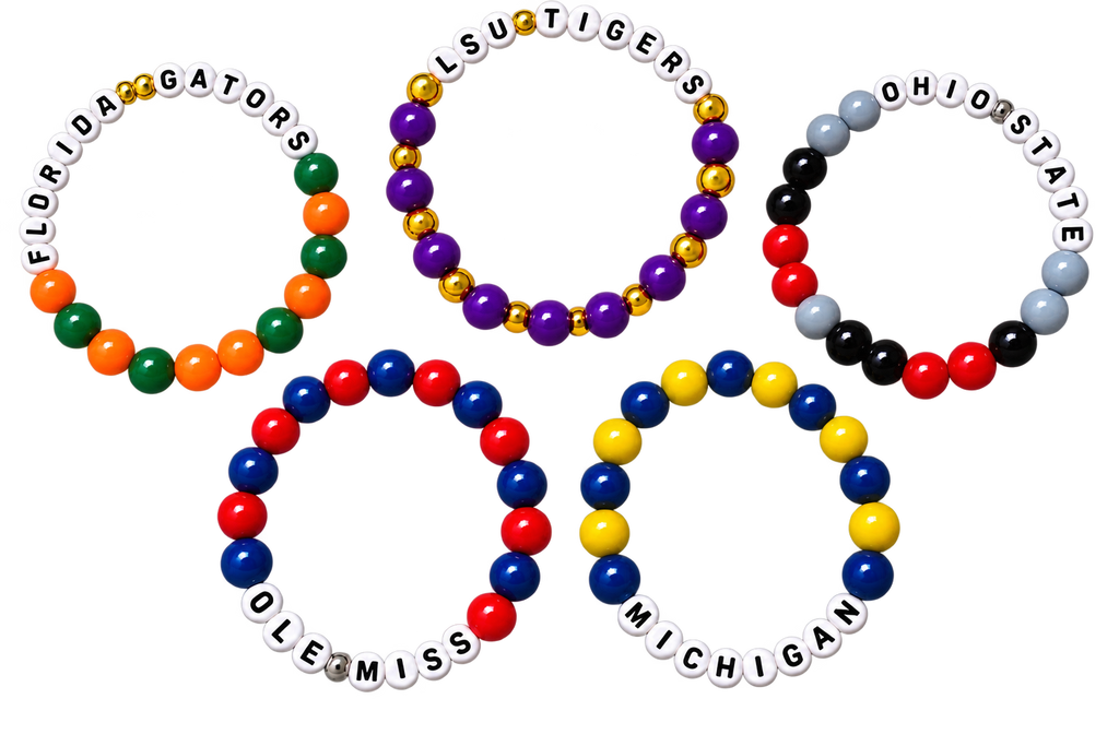 Five beaded championship bracelets arranged in a ring-like layout on a plain white background. Each bracelet features team lettering for Florida Gators, LSU Tigers, Ohio State, Ole Miss, and Michigan, with beads in multiple bright colors including white, red, blue, yellow, green, orange, black, and purple.